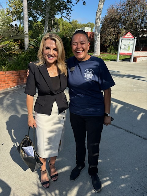 Two community event attendees standing together outdoors