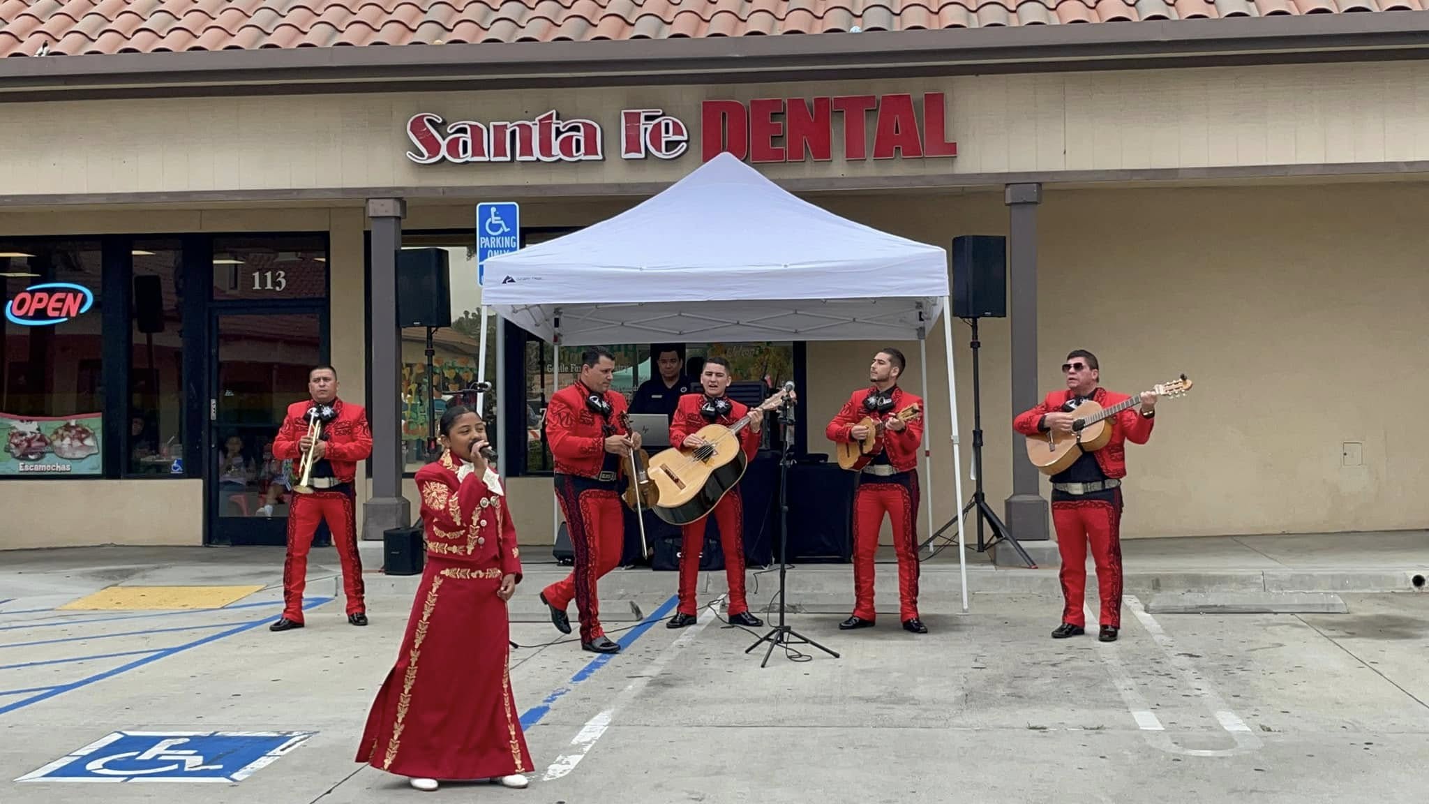 Mariachi musicians performing outside Santa Fe Dental Group at the Fiestas Patrias celebration